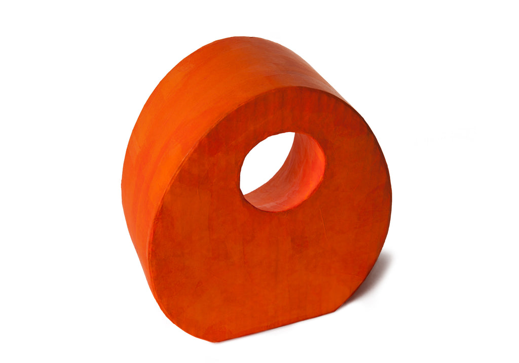 Picture of a beautiful orange tear drop shaped biodegradable paper cremation urn on sale at Muses Design Urns. Back view.