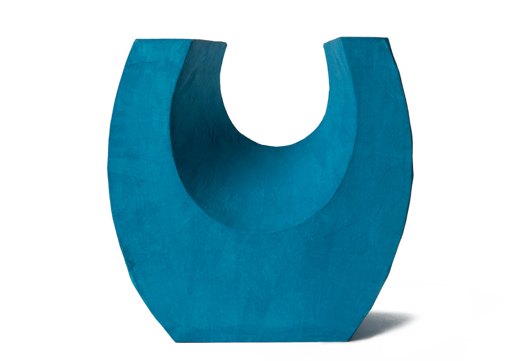 Picture of a beautiful aqua horseshoe shaped biodegradable paper cremation urn on sale at Muses Design Urns. Front view.