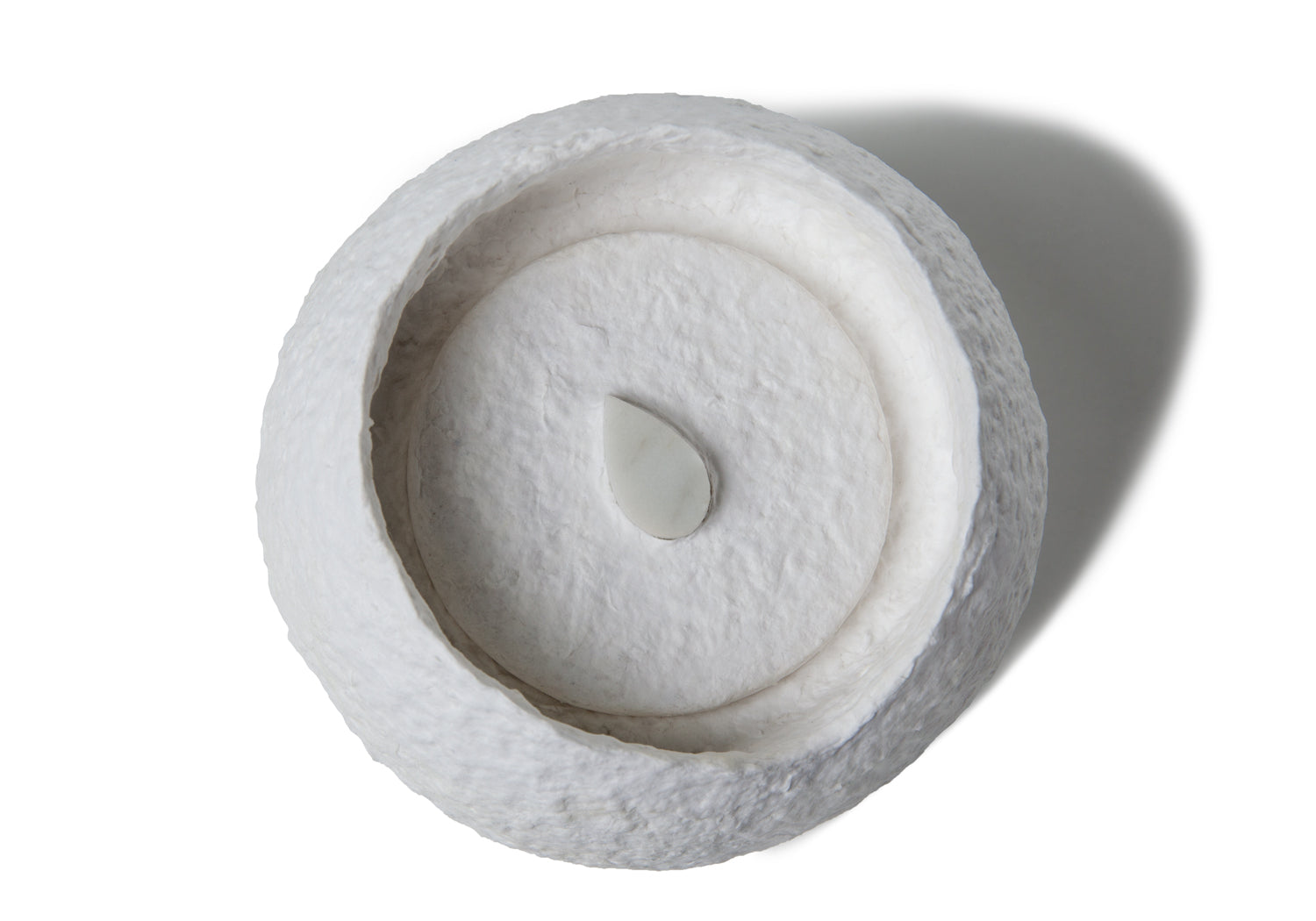 Picture of a white round shape biodegrdable coton fibre cremation urn for children on sale at Muses Design Urns. Top view.