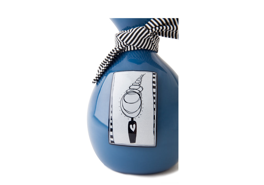 Picture of a deep blue blown glass handkerchief wrapped ball cremation urn for children on sale at Muses Design Urns. Close-up view.