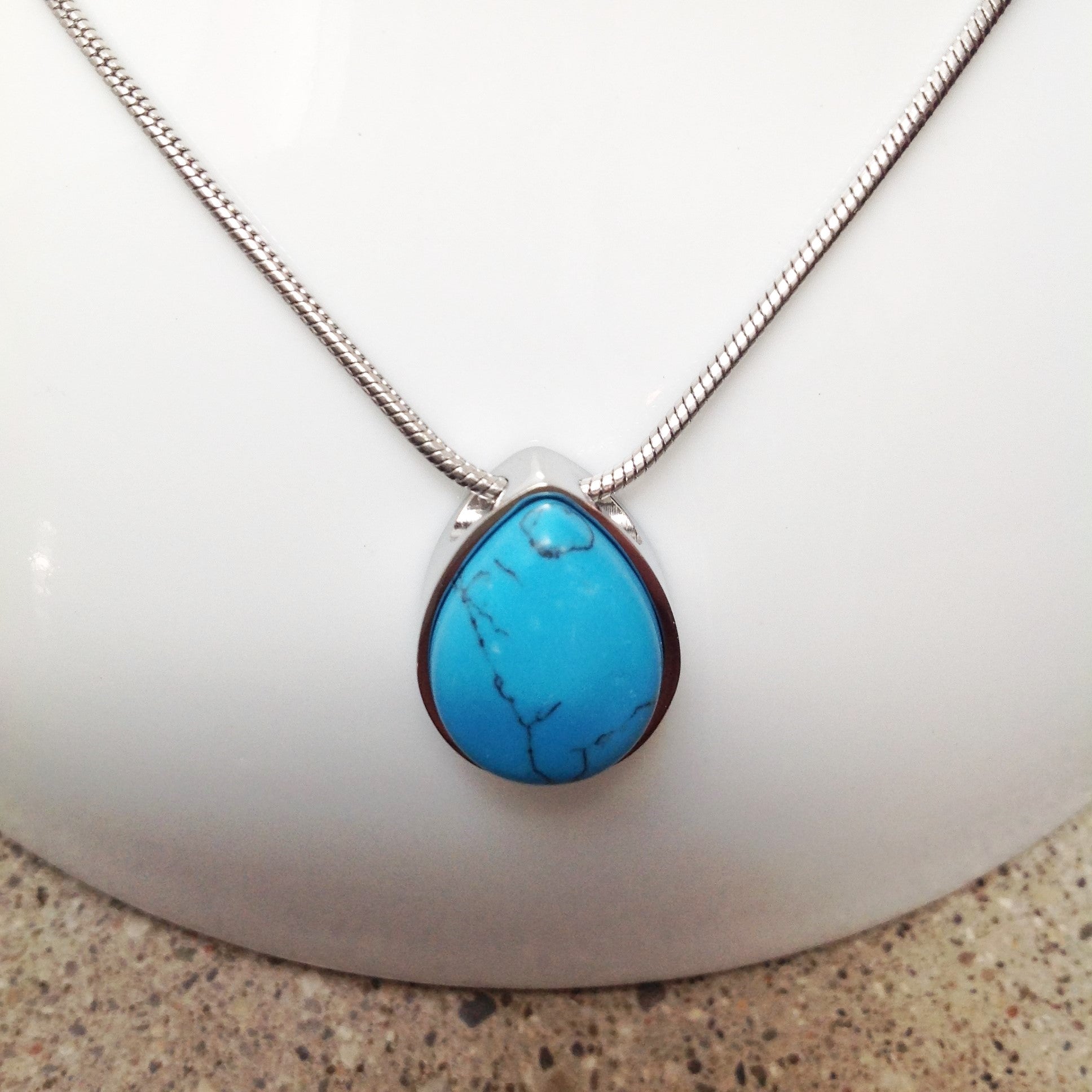 Picture of a Stainless Steel  cremation jewelry with a small-drop pendant for ashes