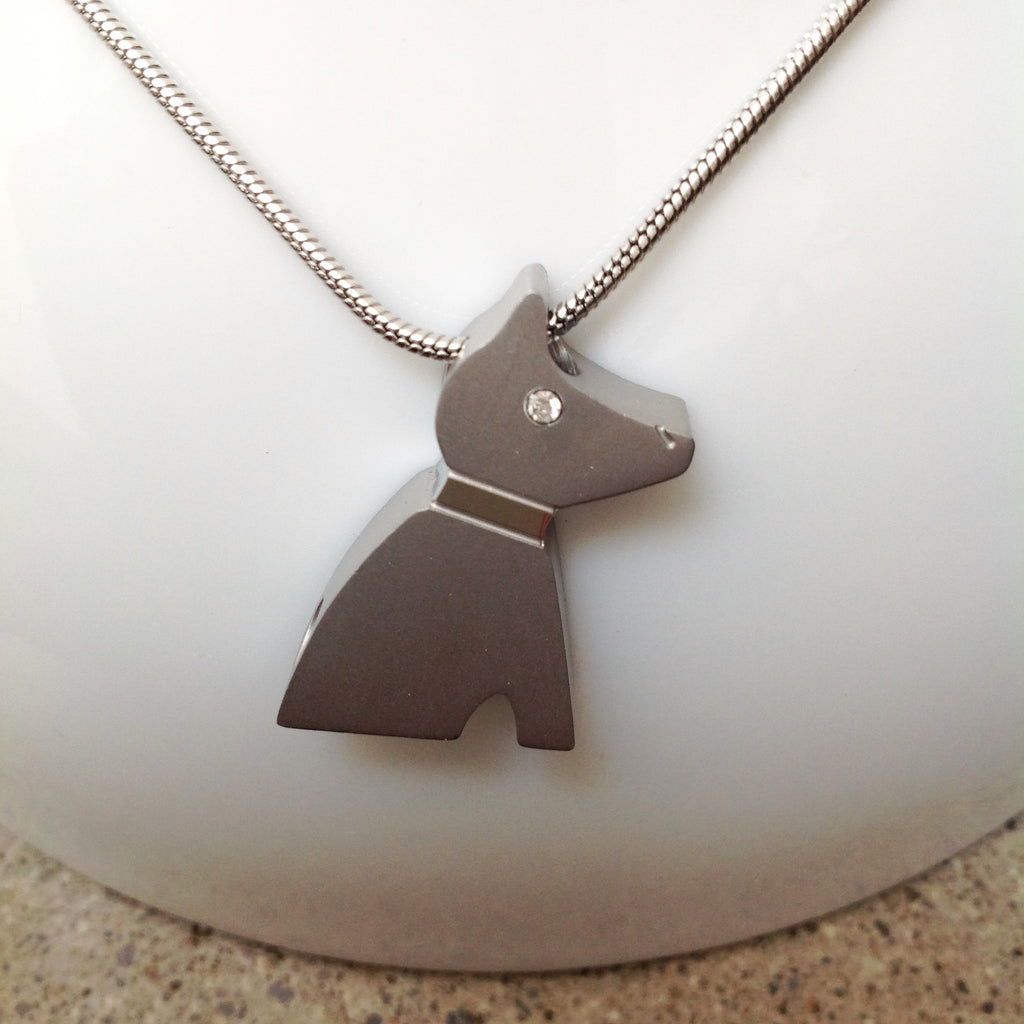 Picture of a Stainless Steel  cremation jewelry with a dog pendant for ashes